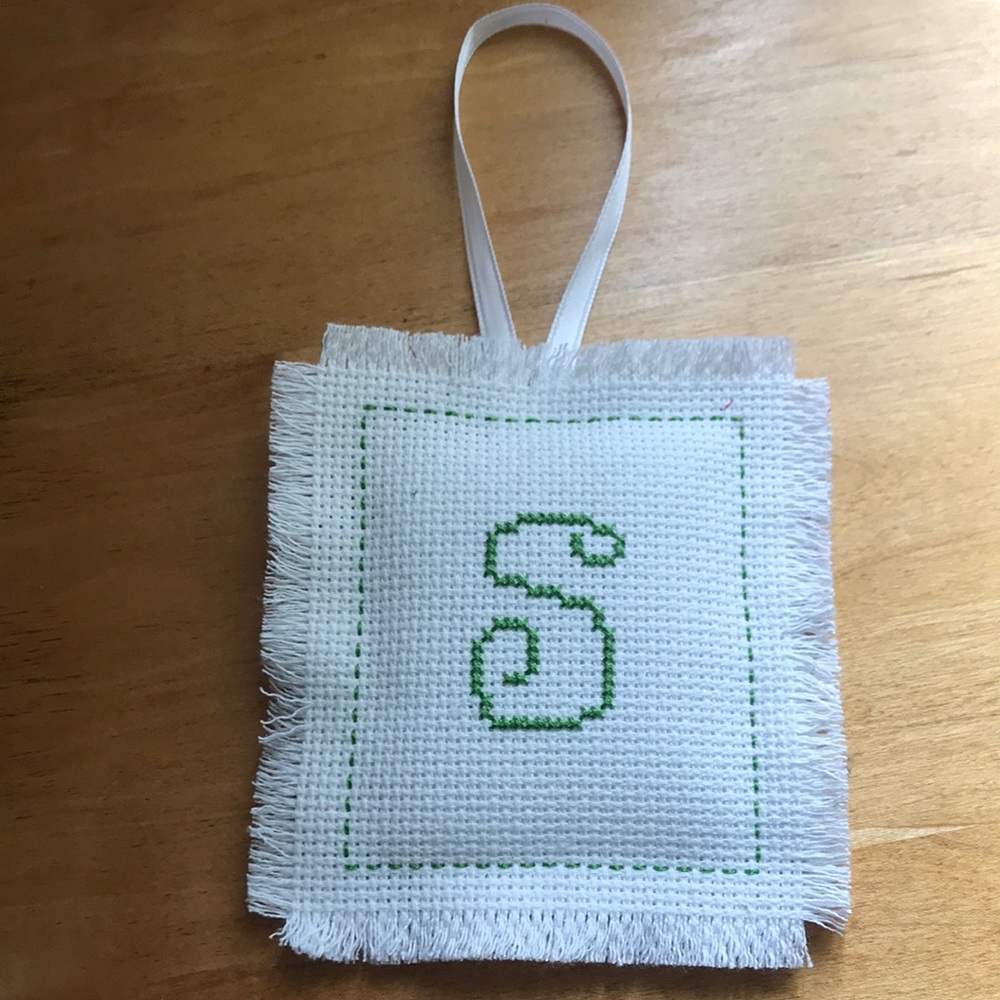 Handmade cross stitch ornament or wall decoration with letter S